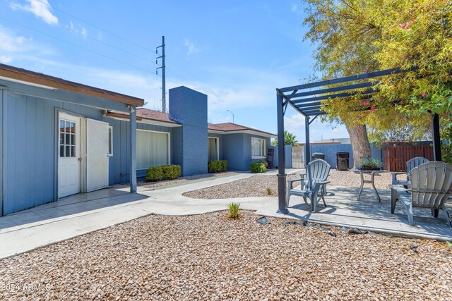 view of yard featuring fence and a pergola