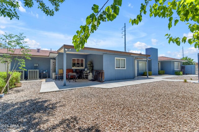 back of property featuring cooling unit and a patio area