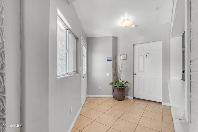 entrance foyer featuring baseboards and light tile patterned floors