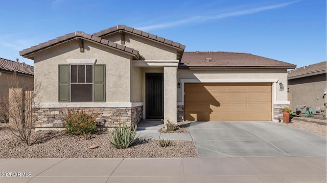 view of front of property with an attached garage, stucco siding, concrete driveway, stone siding, and a tiled roof