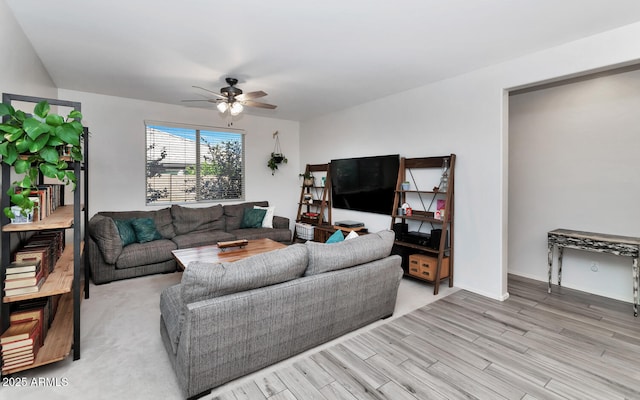 living room featuring light wood-style flooring and ceiling fan