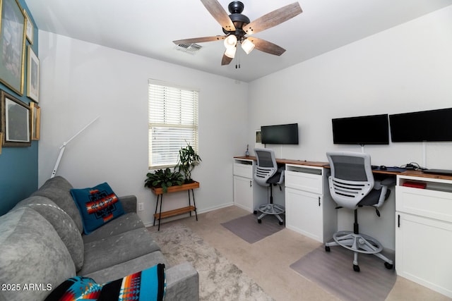 office with visible vents, baseboards, light colored carpet, and ceiling fan