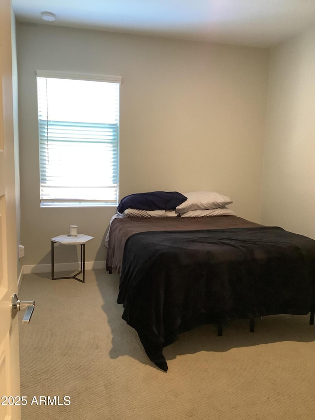 carpeted bedroom with baseboards