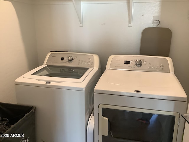laundry area featuring washing machine and dryer and laundry area