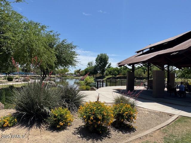 surrounding community with a gazebo and a water view