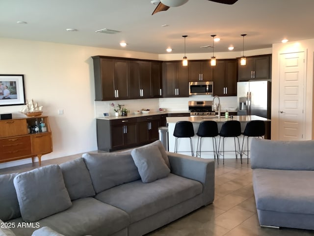 living area featuring light tile patterned flooring, visible vents, ceiling fan, and recessed lighting