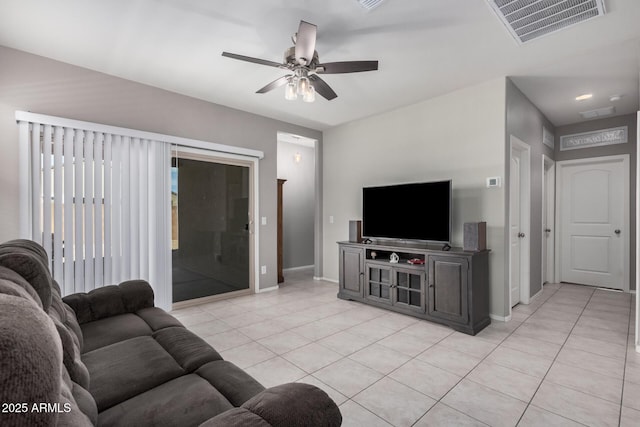 living room featuring light tile patterned floors, baseboards, visible vents, and a ceiling fan