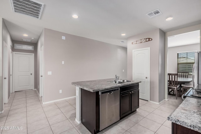 kitchen with a kitchen island with sink, stainless steel dishwasher, a sink, and visible vents