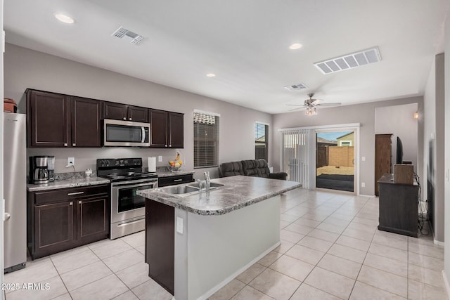 kitchen with open floor plan, appliances with stainless steel finishes, light tile patterned floors, and visible vents