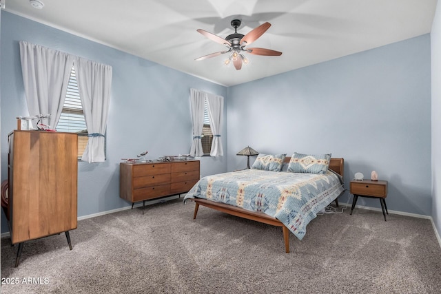 carpeted bedroom with ceiling fan and baseboards