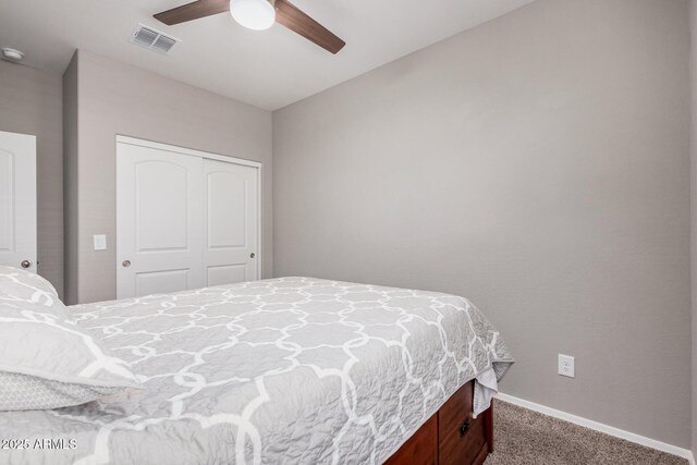 bedroom with a closet, visible vents, carpet flooring, ceiling fan, and baseboards