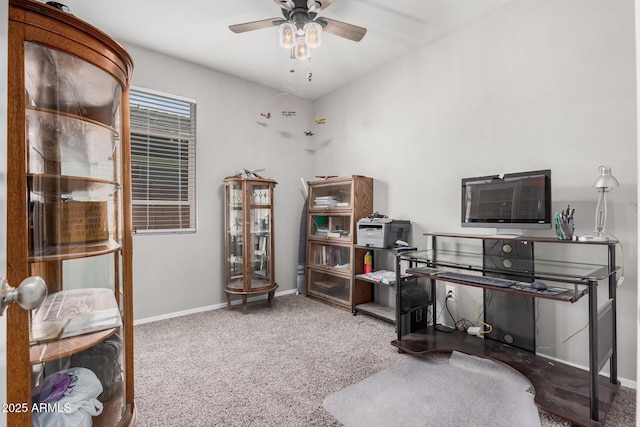 carpeted home office featuring baseboards and a ceiling fan