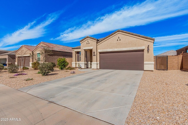 mediterranean / spanish-style home featuring a garage, driveway, a tiled roof, a gate, and stucco siding