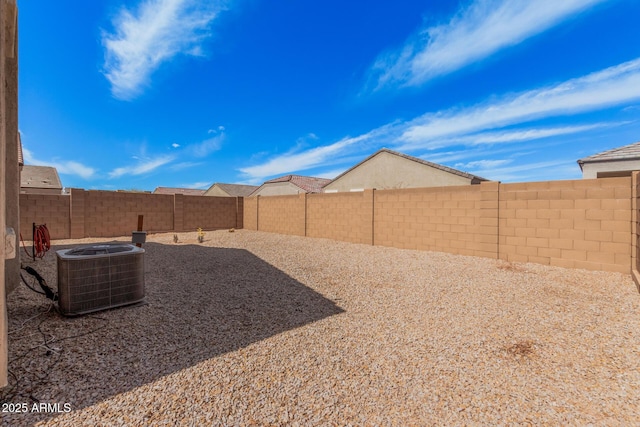 view of yard with a fenced backyard and central air condition unit