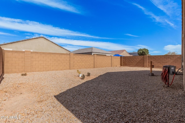 view of yard with cooling unit and a fenced backyard