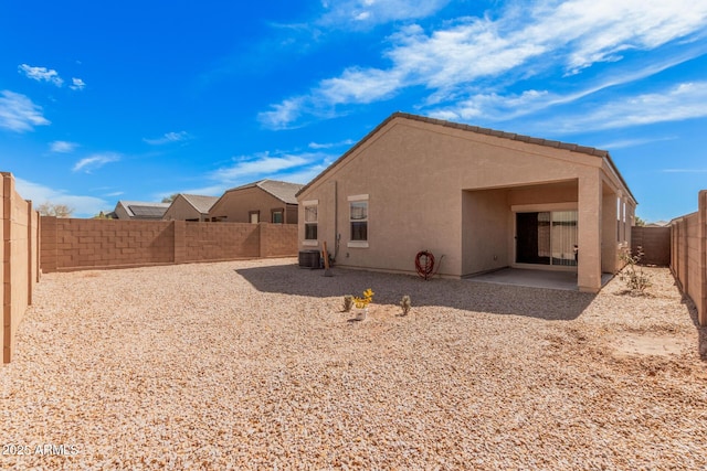 back of property featuring a fenced backyard, a tiled roof, central air condition unit, a patio area, and stucco siding