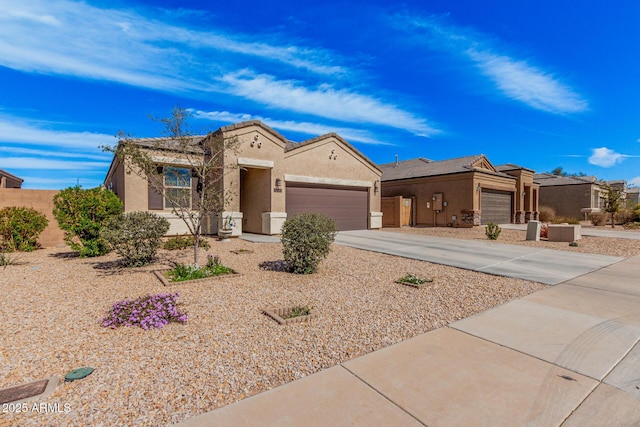 view of front of property with driveway, a tiled roof, an attached garage, and stucco siding