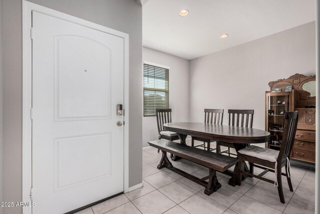 dining area featuring baseboards, light tile patterned flooring, and recessed lighting