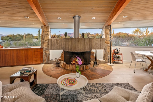 interior space with sink, a wealth of natural light, wooden ceiling, and beam ceiling