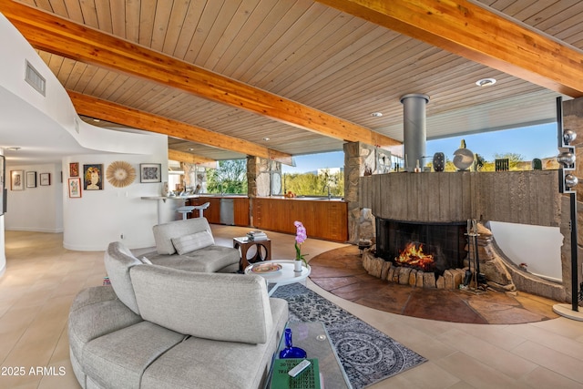 living room featuring beamed ceiling and wood ceiling