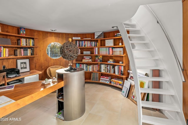 office with built in shelves and wood walls