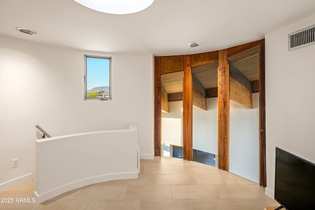 hall with light tile patterned floors