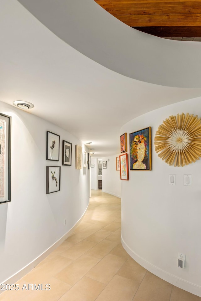 hall with light tile patterned floors