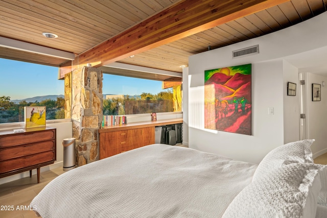 bedroom featuring beamed ceiling, a mountain view, and wooden ceiling