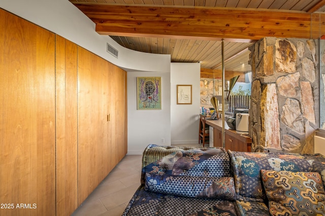 living room featuring beamed ceiling, wood ceiling, and light tile patterned floors