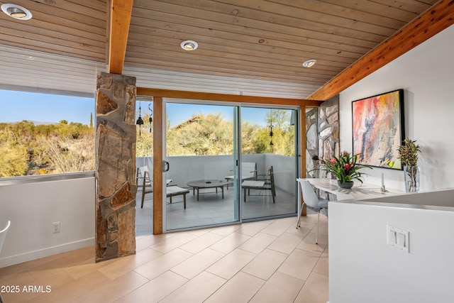 sunroom / solarium featuring plenty of natural light, wooden ceiling, and beamed ceiling