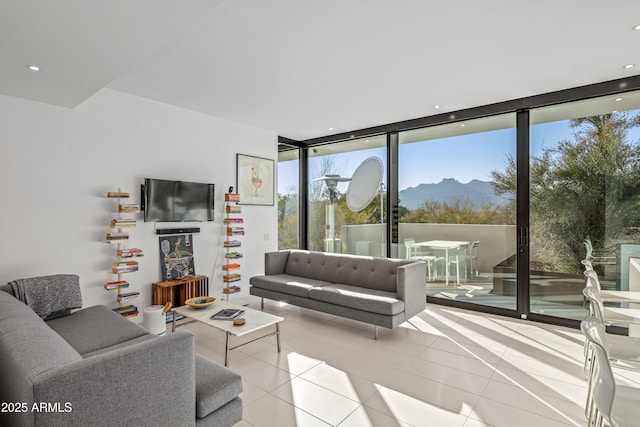 tiled living room featuring a wall of windows