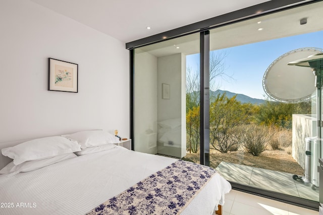 bedroom with floor to ceiling windows, a mountain view, and light tile patterned flooring