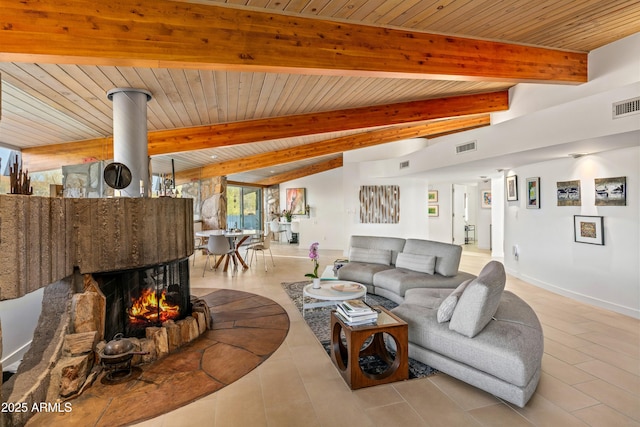 living room featuring beam ceiling, light tile patterned floors, and wooden ceiling