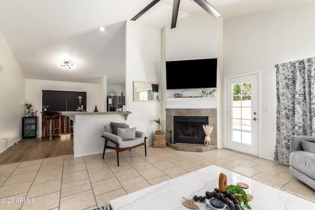 19230 N 5th St, Phoenix, AZ 85024 - living room featuring high vaulted ceiling, a tiled fireplace, tile patterned flooring, beam ceiling, and a ceiling fan