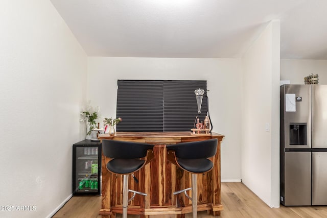 19230 N 5th St, Phoenix, AZ 85024 - indoor dry bar featuring stainless steel refrigerator with ice dispenser, light wood-style flooring, and wine cooler