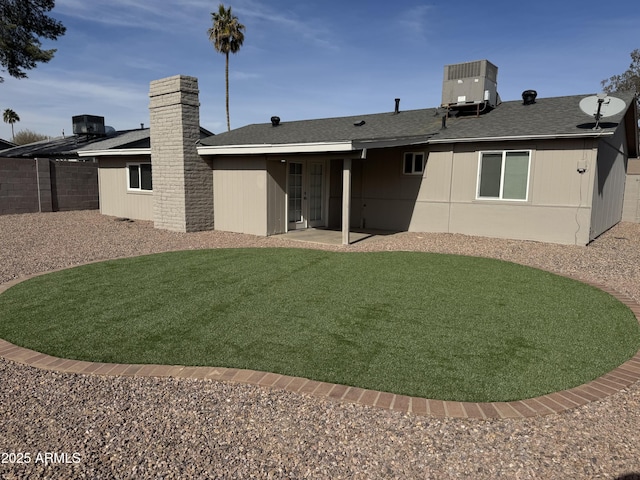 back of house featuring a lawn, cooling unit, and a patio area