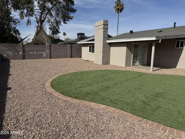 view of yard featuring central AC and a patio