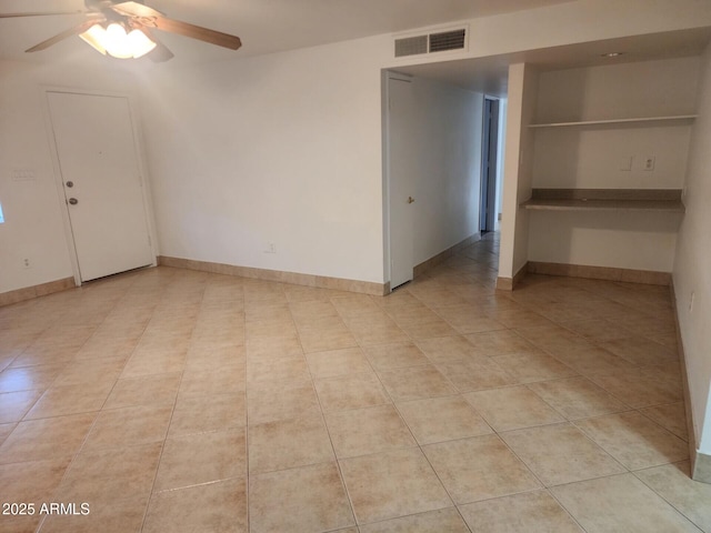 unfurnished room featuring light tile patterned floors and ceiling fan