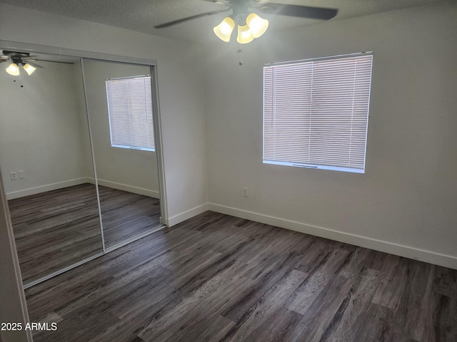 unfurnished room with dark hardwood / wood-style flooring, a textured ceiling, and ceiling fan