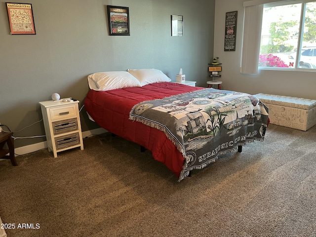 bedroom with baseboards and dark colored carpet