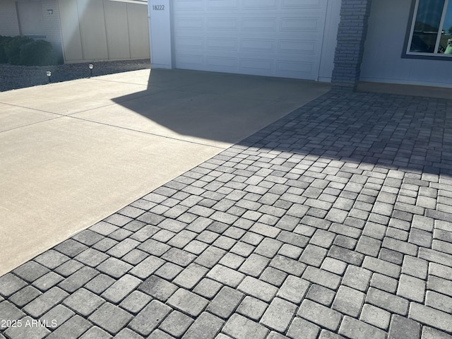 exterior space with a garage and concrete driveway