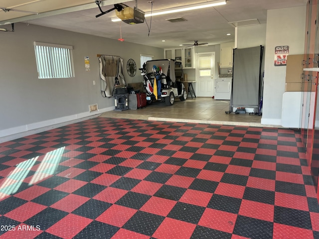 garage featuring a garage door opener, washer / clothes dryer, a ceiling fan, freestanding refrigerator, and baseboards