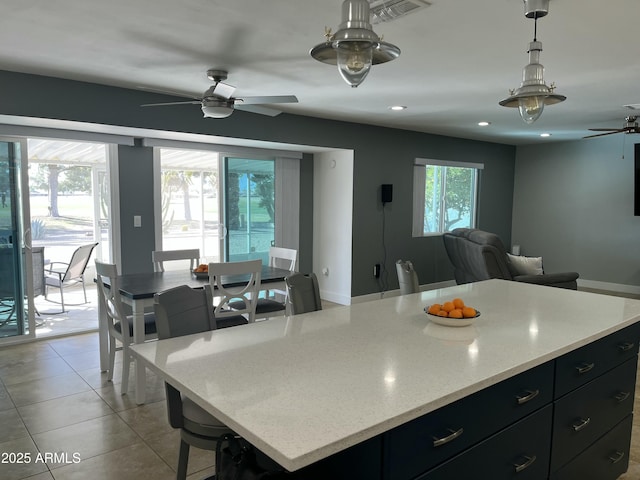 kitchen featuring light tile patterned floors, visible vents, open floor plan, dark cabinetry, and recessed lighting