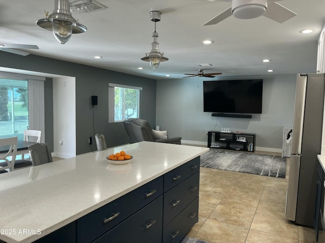 kitchen with ceiling fan, recessed lighting, visible vents, freestanding refrigerator, and decorative light fixtures