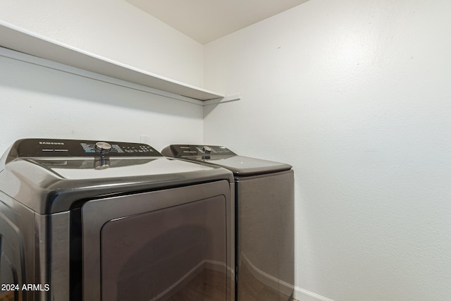 laundry area featuring washing machine and dryer and hardwood / wood-style floors