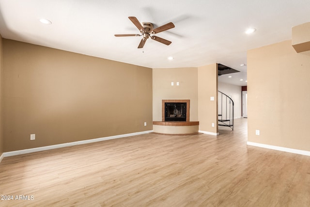 unfurnished living room with ceiling fan and light hardwood / wood-style flooring