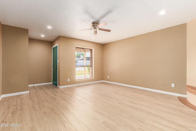 unfurnished room featuring ceiling fan and light hardwood / wood-style flooring