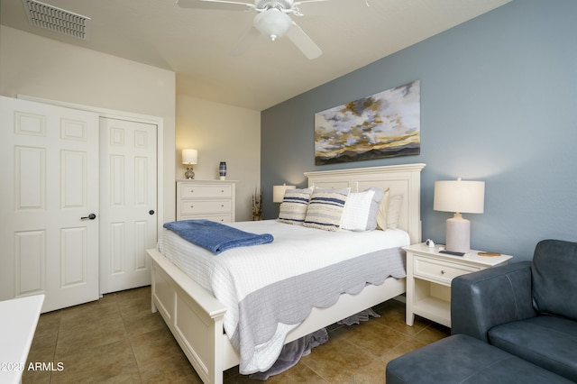 bedroom featuring ceiling fan, a closet, tile patterned flooring, and visible vents