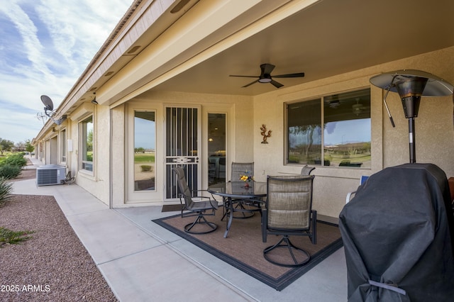 view of patio featuring outdoor dining space, cooling unit, and a ceiling fan