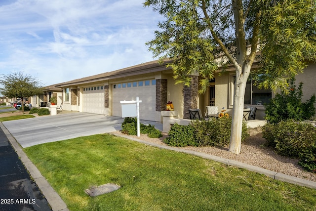 view of front of house featuring a front lawn, concrete driveway, an attached garage, and stucco siding